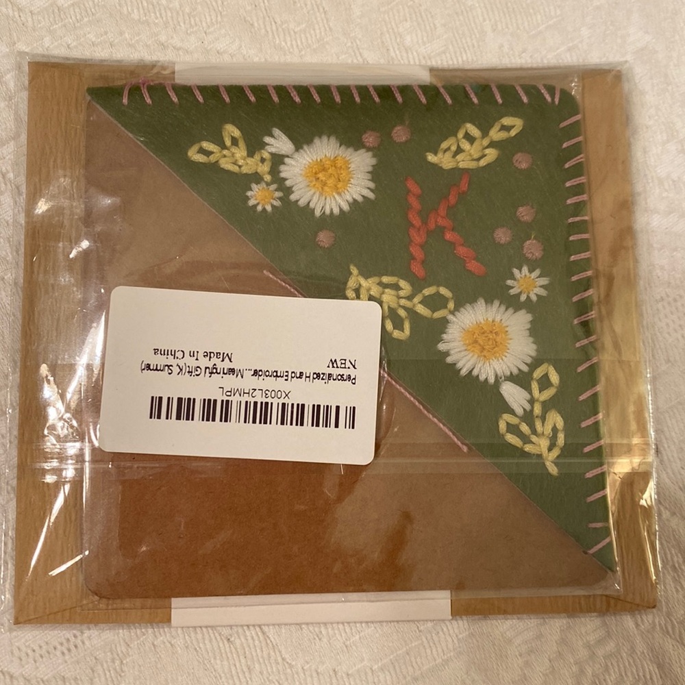 Book mark embroidered with “K” and summer flowers. Slides onto edge of page.